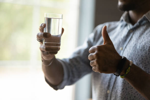 Satisfied mixed raced Black young man approving water quality