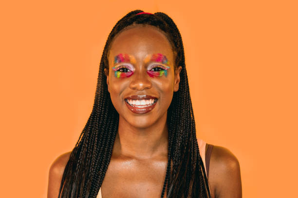 istock Studio portrait of a black woman with rainbow make-up 1389723614