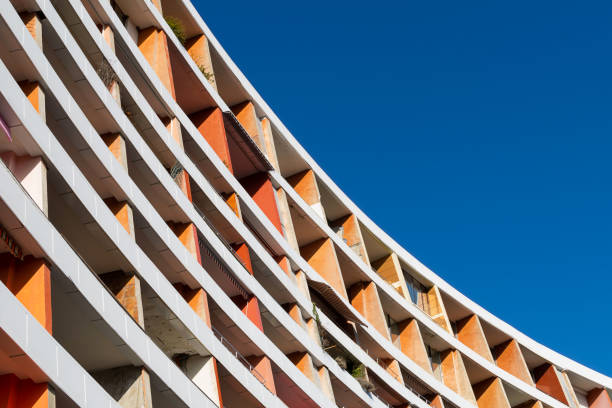 istock Curved old orange building against blue sky. 1389727687