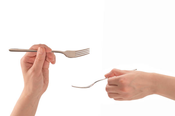 istock Fork in woman hand isolated on white. 1389727809