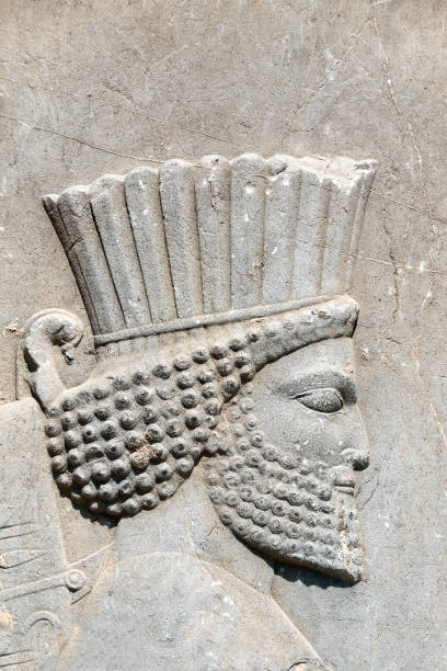 istock Bas-relief with face of assyrian warrior on ancient wall, Persepolis, Iran 1389734362