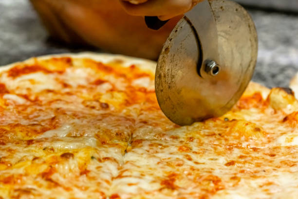 istock The chef cuts the pizza with a special round knife 1389735747