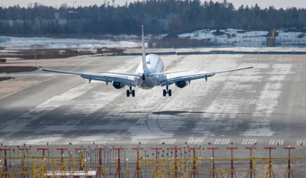 istock Airplane landing to airport runway 1389739671