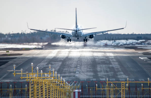 istock Airplane landing to airport runway 1389739749