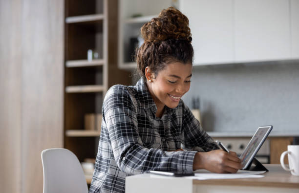 istock Happy young woman working at home 1389740835