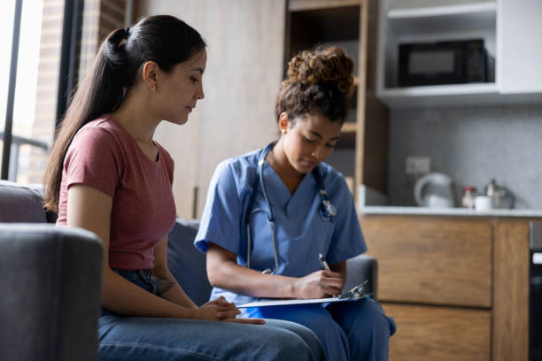 istock Patient talking to a doctor during a house call visit 1389740886