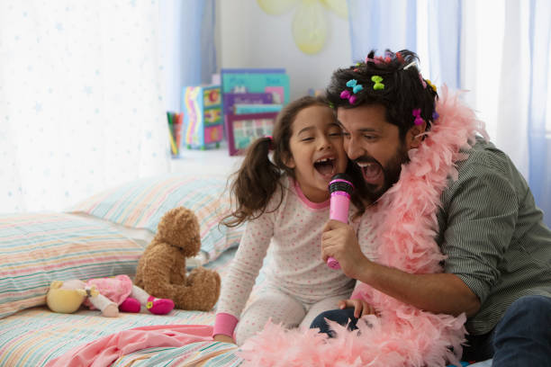 Father and daughter having fun dressing up stock photo