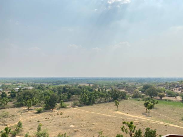 istock Rural village in India with sunlight reflection and blue sky background 1389748988