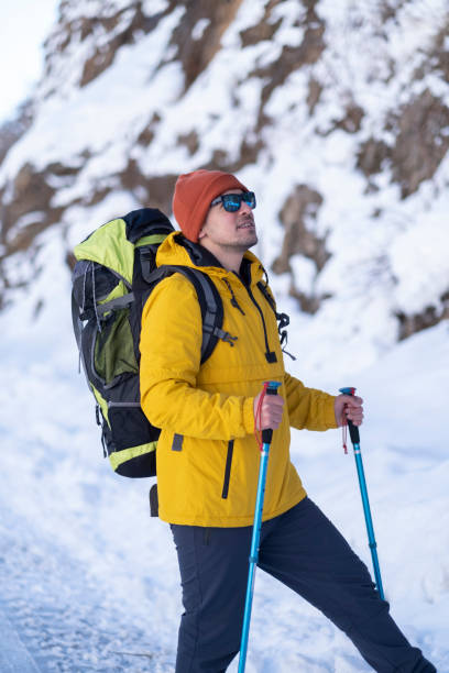 istock Man hiking with backpack in the mountains in winter 1389750460