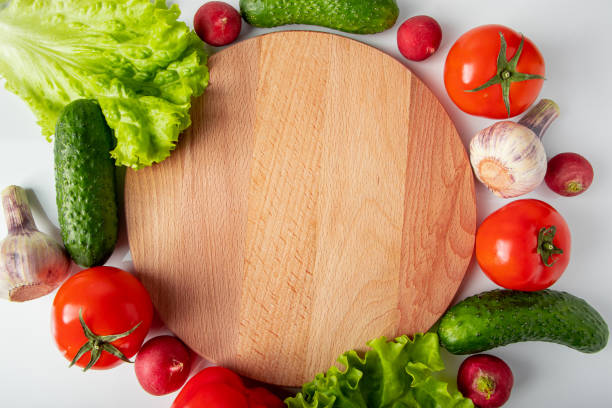istock Fresh raw vegetables on a wooden cutting board. 1389750463