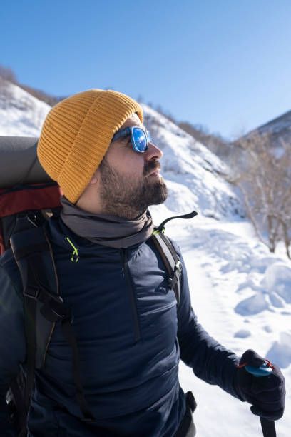 istock Man hiking with backpack in the mountains in winter 1389750605