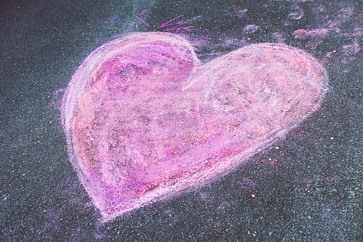 A chalk heart drawing in a driveway.