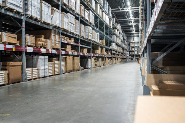istock Distribution warehouse with a lot of shelfs with cardboard boxes 1389751996