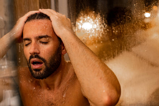 istock Handsome man taking a shower in a hotel room 1389752260
