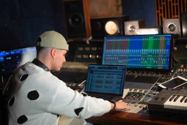 istock Young music producer working in sound recording studio 1389752329