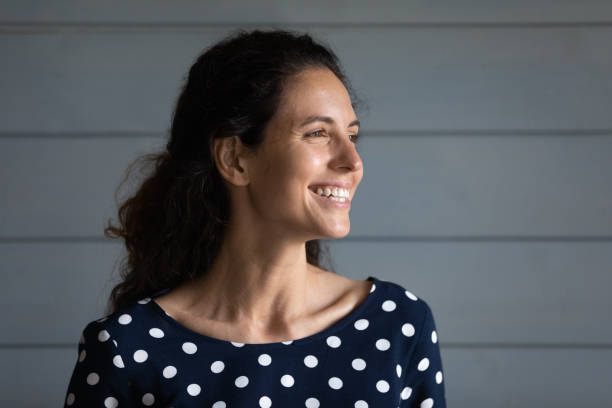 istock Optimistic millennial latin woman smiling looking at distance creating plan 1389752870