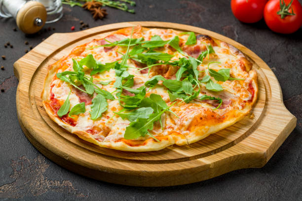 istock pizza with bacon and aragula on dark concrete table 1389754623