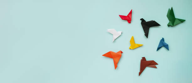 istock eight paper origami pigeons different colors on light blue background 1389754907