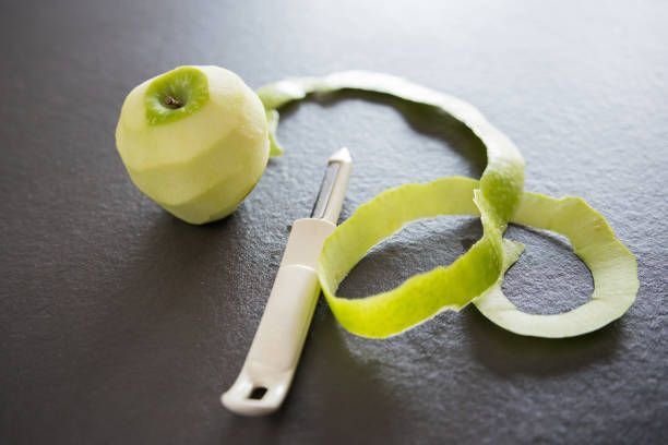 Peeling a green apple . Homemade cookies