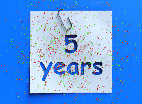 Five year paper confetti sign