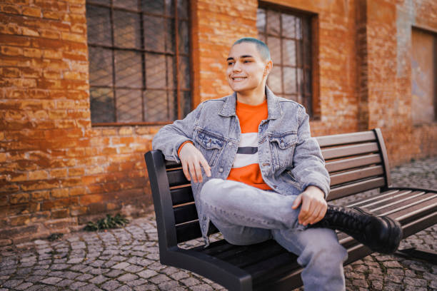 istock Young man taking a break on park bench 1389758369