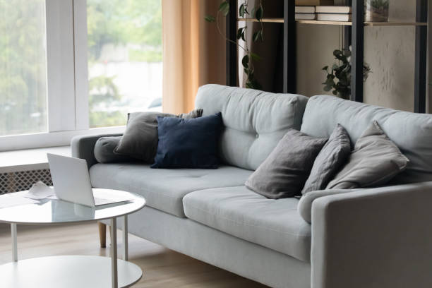 istock Living room with grey sofa and laptop on coffee table 1389758496