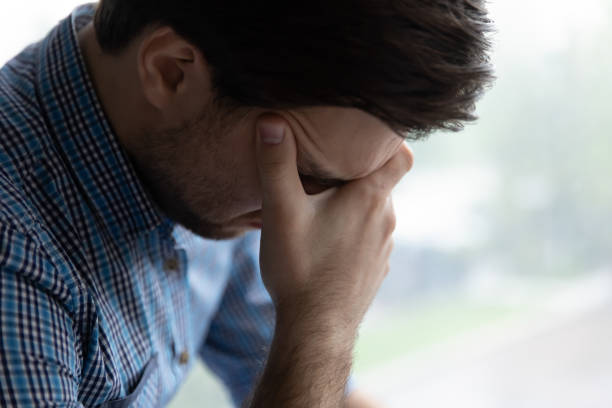 istock Sad hopeless young man sit alone indoor looks desperate 1389758551