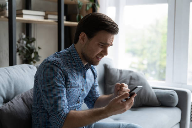 istock Man holds smartphone feels disillusioned losing online lottery 1389759704