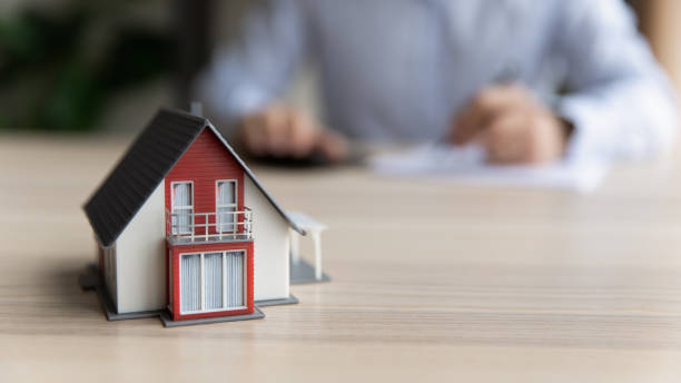 client sits at table signing rental agreement, house layout closeup - house real estate residential structure insurance imagens e fotografias de stock