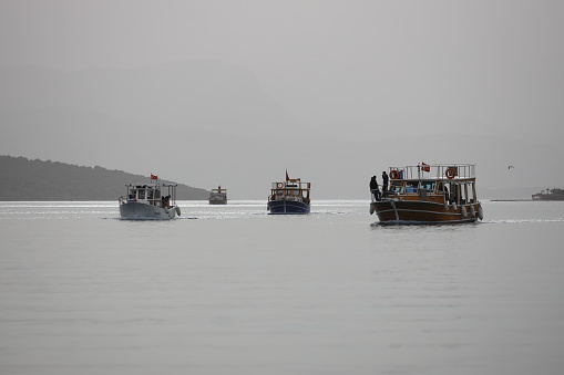 Bodrum, Mugla, Turkey. 03 April 2022. In the desert dust-covered skies, the fishermen who sailed for the weekend are returning. Even the sun is not visible because of the polluted air.