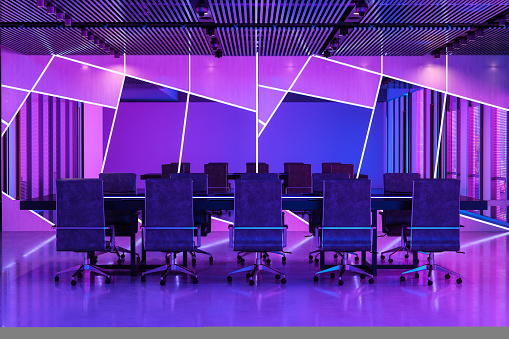 Empty Board Room Interior With Table, Office Chairs And Neon Lighting