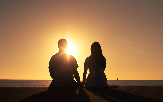 Couple watching sunset together.
