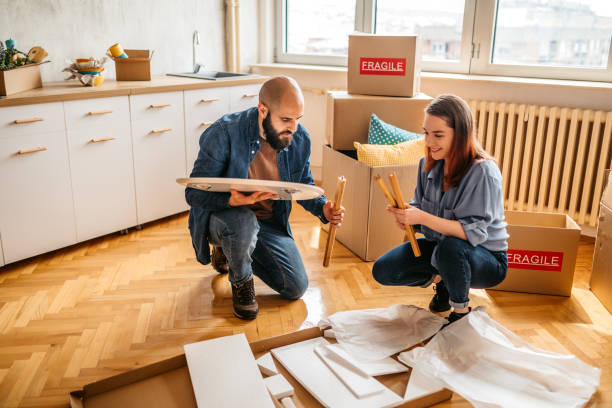 istock Couple assembling coffee table in their new home 1389762812