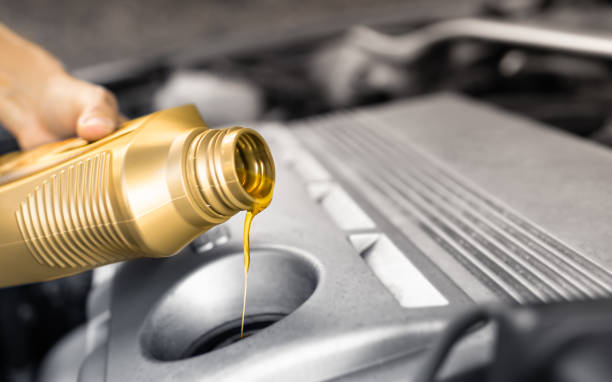 istock Men changing car oil in his car. 1389762815