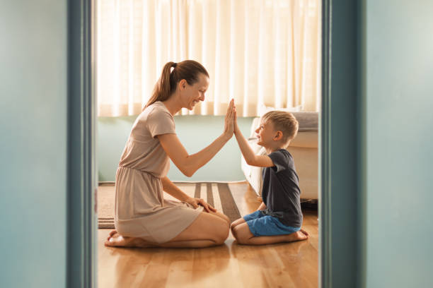 istock Mother and her son giving high five each other. 1389762816