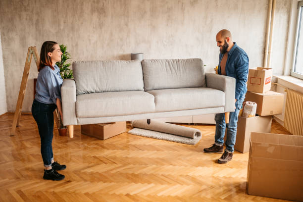 istock Young couple placing sofa in a new home 1389763396