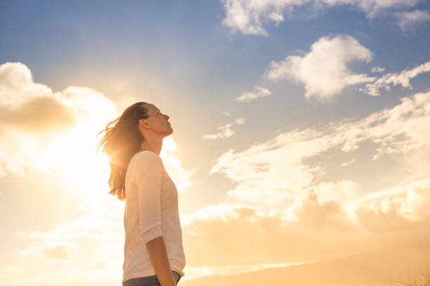 Woman looking up into the sky and thinking about her future. Woman thinking of her future. hope stock pictures, royalty-free photos & images