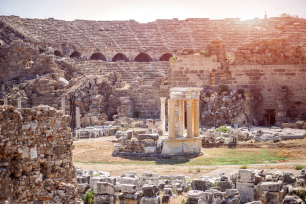 The antique architecture with ruins of amphitheatre on a background in ancient city Side, Turkey. stock photo