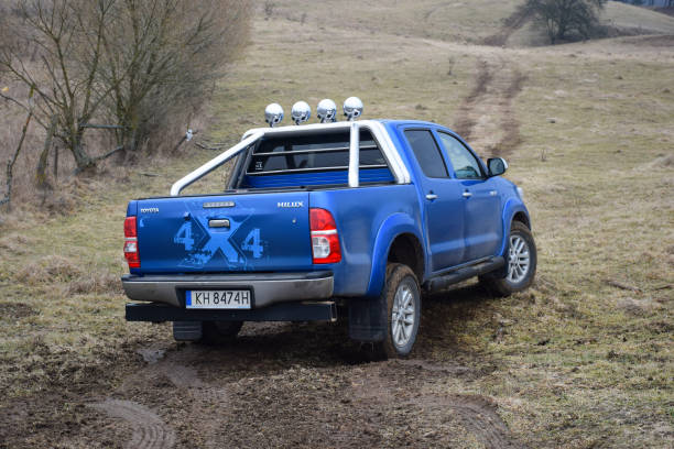 Toyota Hilux on the off-road Warchaly, Poland - 18th February, 2016: Toyota Hilux driving on the off-road. The Hilux is one of the most popular pick-up vehicles in the world. toyota hilux stock pictures, royalty-free photos & images