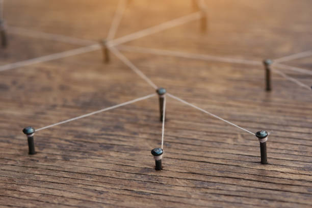 istock Network connected with yarn white on plank wood 1389770505
