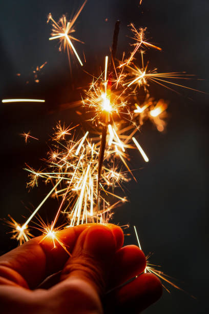 istock Female hand holding a burning sparkler, 1389770541
