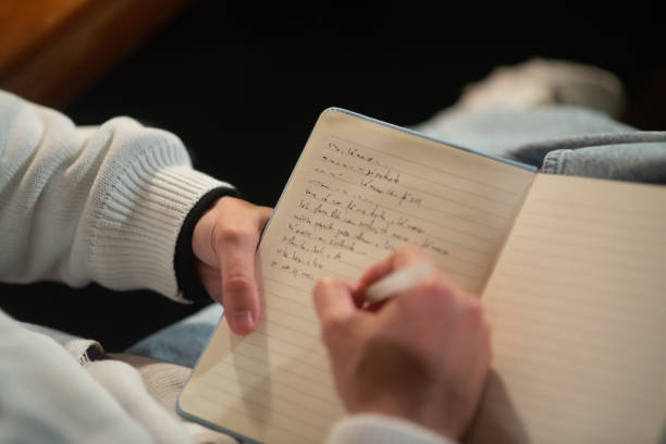 istock Close-up of young Caucasian man taking notes in notepad 1389772516