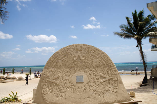 Aztec calendar made of sand on the beach of Playa del Carmen during day of March