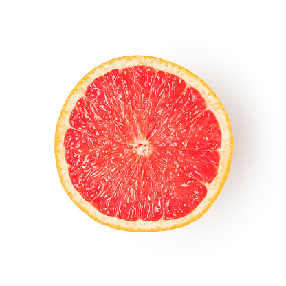 This is a close up photo of pink grapefruit sliced in half that is isolated on a white background with a drop shadow. There is endless space for copy.