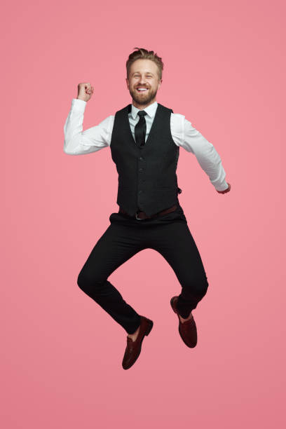 happy businessman jumping and smiling - men businessman jumping levitation imagens e fotografias de stock