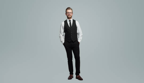 istock Positive businessman with hands in pockets 1389780239