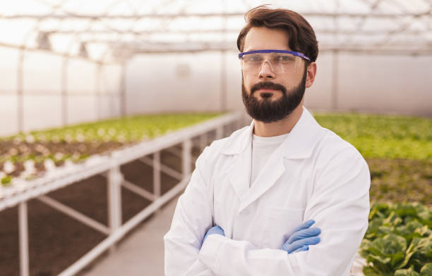 istock Scientist in uniform in modern greenhouse 1389780323