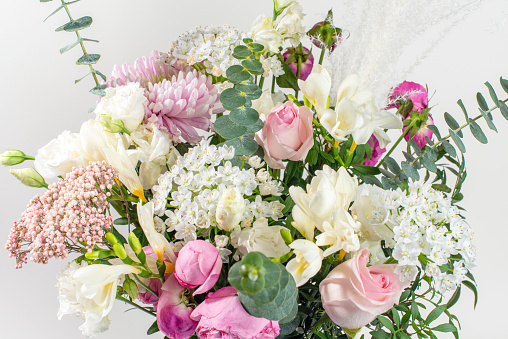 Bouquet of pastel colored flovers on white background. Close up.