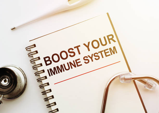 istock Medical concept. Notebook with word BOOST YOUR IMMUNE SYSTEM on white desk with stethoscope and thermometer. 1389781633