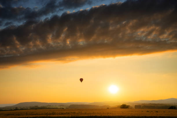 istock Landscape with hot air balloon at sunset with dramatic clouds 1389781887